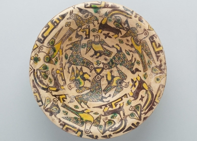 Bowl with Birds, Ibex, Floral, Calligraphic and Geometric Motifs, Nishapur, Iran, 9th-10th century, Abbasid Period (750-1258), Buff clay body with dark brown slip and yellow, green and clear glazes, Purchase 1970 John O’Neill Fund, Collection of the Newark Museum 70.16