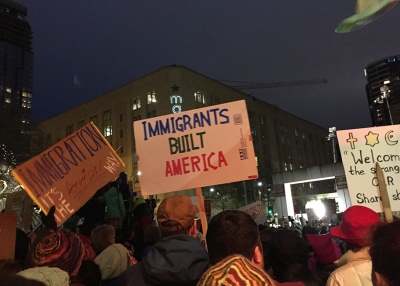 A sign that reads "Immigrants Built America" at a rally in Seattle, Washington.