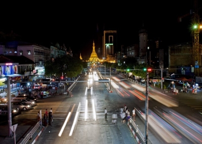 Commuters cross a busy street at night in Yangon, Myanmar in May 2014. (Ye Aung Thu/AFP/Getty Images)