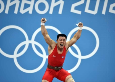 GOLD: North Koreas's Kim Un Guk celebrates his new world record during the weightlifting men's 62kg group A event on July 30, 2012. (Yuri Cortez/AFP/GettyImages)