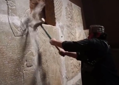 An Islamic State militant participating in the destruction of ancient ruins near the city of Nimrud, Iraq, in a video released by the Islamic State.