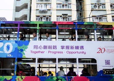 Commuters travel in a tram with a design commemorating the 20th anniversary since the city was handed back to China by colonial ruler Britain, in a residential neighborhood of Hong Kong (ANTHONY WALLACE/AFP/Getty Images).
