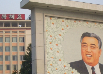 A mural of Kim Il Sung in the foreground (Anne Hilton)