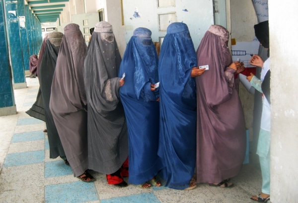 Women queue in Kandahar on August 1 to learn how to vote in the August 20 presidential election. The Independent Election Comission (IEC) held a 4-day training program for Afghan women and men to teach them how to vote. (Hamed Zalmy/AFP/Getty Images)