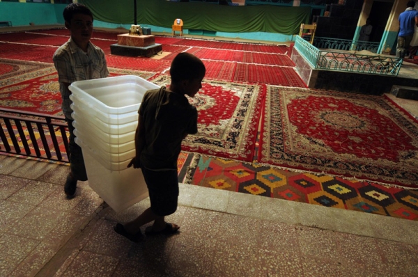 Employees from the Independent Election Comission (IEC) carry ballot boxes inside a polling station in Kabul on August 18.  (Shah Marai/AFP/Getty Images)
