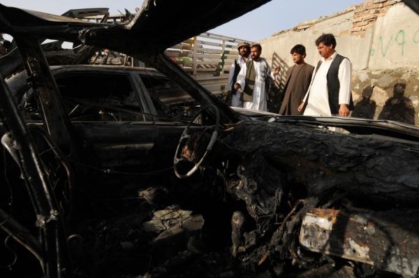 Kabul residents inspect the site of a suicide car bomb attack on August 18. Taliban attacks rocked Afghanistan two days before elections as suicide bombers killed more than 12 people and a rocket slammed into the presidential compound. (Shah Marai/AFP/Getty Images)
