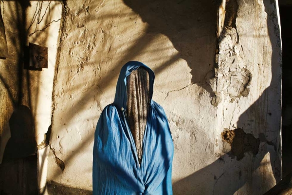 An Uzbek woman poses outside her home in the town of Karasu. From "Two Rivers." (Carolyn Drake)