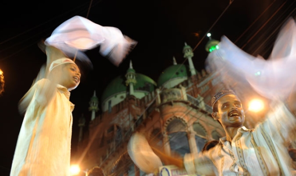 Indian street vendors hawk handkerchiefs in front of The Nakhoda Mosque in Kolkata