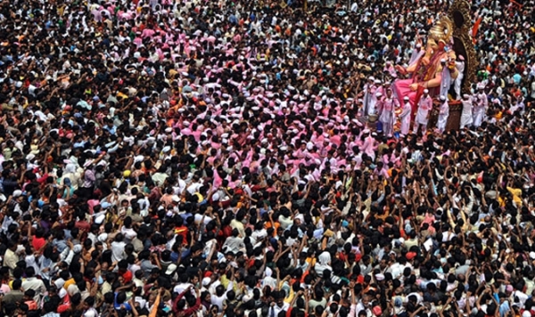 Devout Indian Hindus throng a main road in Mumbai as a huge idol of the elephant-headed Hindu god Lord Ganesha is transported for immersion into the Arabian Sea during the Ganesha Festival