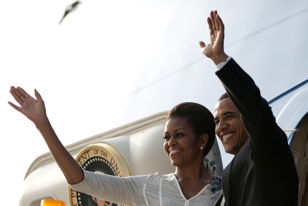 US President Barack Obama (R) and First Lady Michelle Obama wave after boarding Air Force One as they depart New Delhi on November 9, 2010. (Jim Watson/AFP/Getty Images)