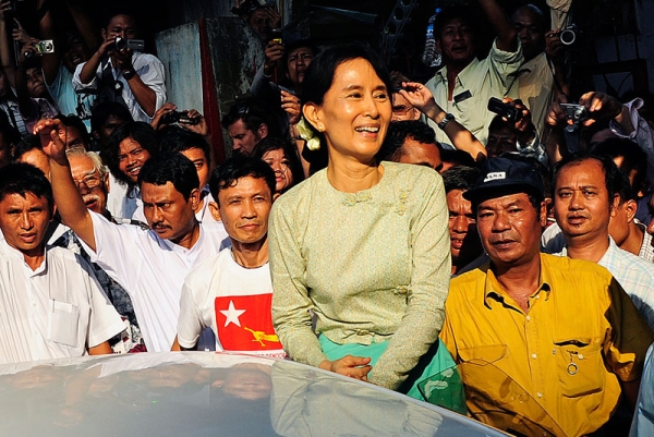 Myanmar's newly-released opposition leader Aung San Suu Kyi (C) smiles as she arrives at the National League for Democracy (NLD) headquarters in Yangon on November 15, 2010. (STR/AFP/Getty Images)