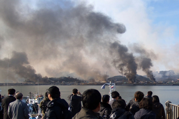 Photo taken by a South Korean tourist shows plumes of smoke rising from Yeonpyeong island in the disputed waters of the Yellow Sea after North Korea fired dozens of artillery shells, Nov 23, 2010., killing two people. (STR/AFP/Getty Images)