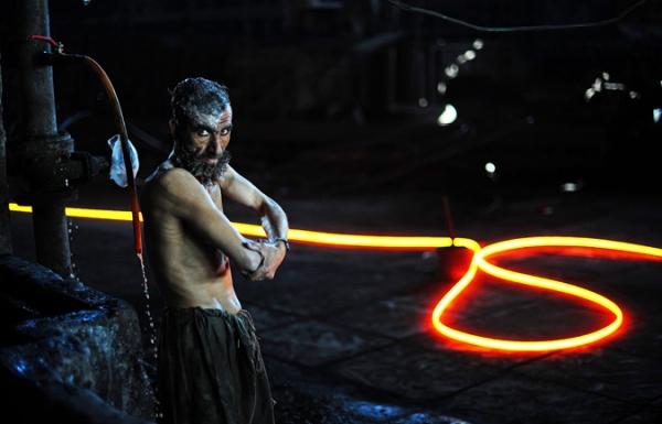 A steel worker is pictured as he washes after working with molten steel at Ittehad Steel Mill Islamabad on November 30, 2010.