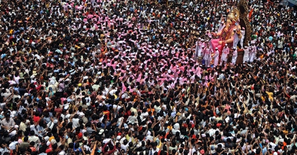 Devout Hindus throng Mumbai&apos;s main road as a huge Ganesh idol is transported for immersion into the Arabian Sea on September 22, 2010. Hindus invoke Ganesh&apos;s blessings for wisdom and prosperity during the festival, which culminates with the immersion of the idols in bodies of water. (Indranil Mukherjee/AFP/Getty Images)