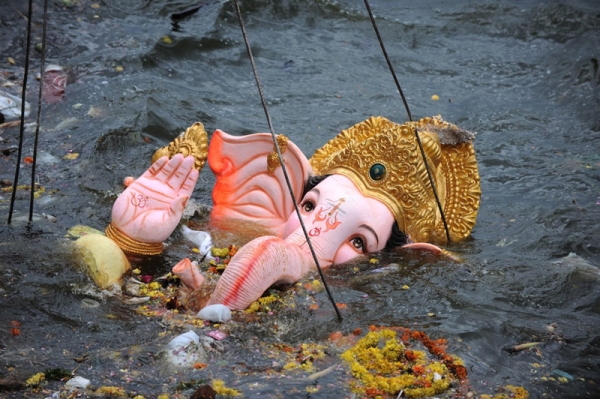 Ganesh is hoisted by a crane into Hussainsagar Lake in Hyderabad on September 22, 2010. (Noah Seelam/AFP/Getty Images)