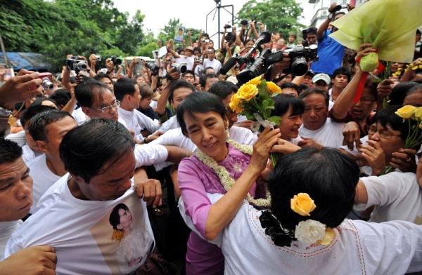 Myanmar's democracy icon Aung San Suu Kyi (C) walks through a crowd of supporters and reporters as she arrives for celebrations of her 66th birthday at the National League for Democracy (NLD) headquarters in Yangon on June 19, 2011. (Soe Than Win/AFP/Getty Images)