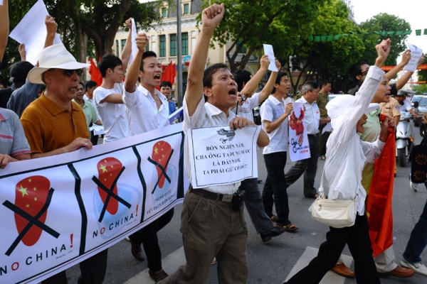 Vietnamese protesters shout anti-China slogans at a rally in central Hanoi on Aug. 14, 2011. About 100 people took to Hanoi's streets to protest against Beijing's territorial ambitions in the South China Sea. (Hoang Dinh Nam/AFP/Getty Images)