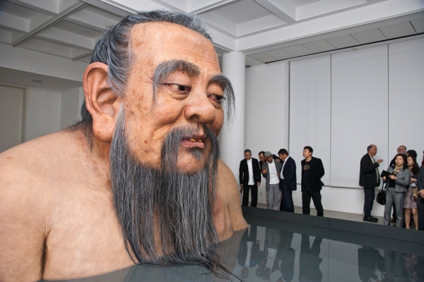 Visitors to the Rockbund Art Museum in Shanghai, China, react to a sculpture of Confucius by artist Zhang Huan. (Rockbund Art Museum)
