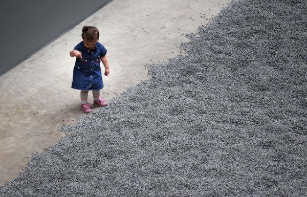 A child plays with some of the seeds in Ai Weiwei's 'Sunflower Seeds' at The Tate Modern in London, England on Oct. 11, 2010. (Peter Macdiarmid/Getty Images)