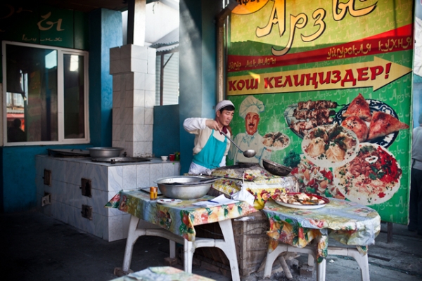 A Kyrgyz cook is preparing a range of local cuisine in anticipation of the lunch-hour crowd in a bazaar in Bishkek. (Sue Anne Tay)