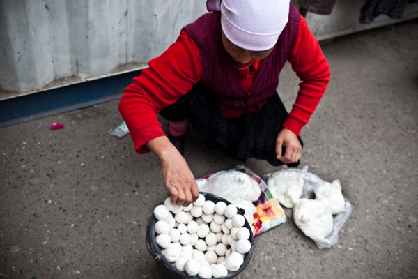 A female vendor arranges local candy in Osh Bazaar. (Sue Anne Tay)