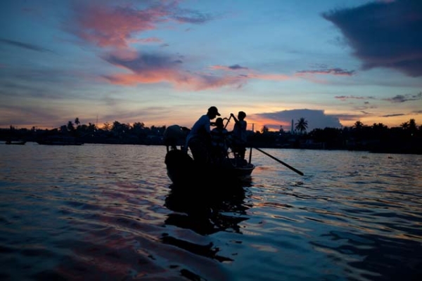 Dawn patrol: vendors heading to market get an early start on the Mekong River in Vietnam. (Hélène Franchineau)