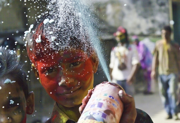 A young boy covered in red powder for Holi, the Festival of Color on March 8, 2012 in Kathmandu, Nepal. (satyamjoshi/Flickr)