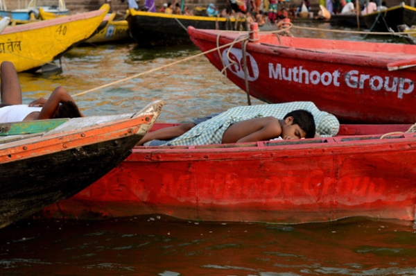 A boy napping in a boat along the banks of Ganges in Varanasi, India on July 2, 2012. (Shivika Sinha)