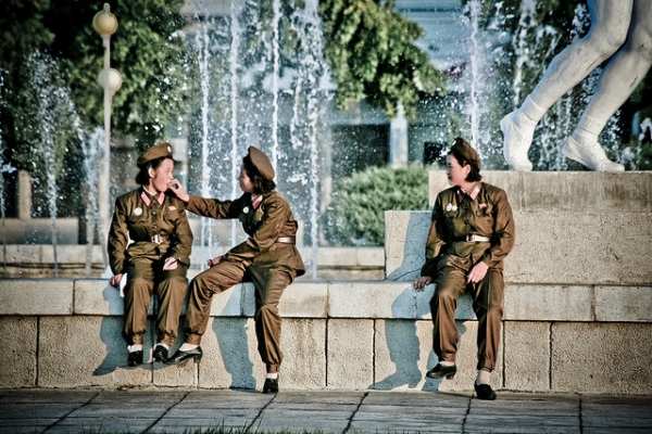 Three uniformed women take a break by a fountain in Pyongyang, North Korea on September 25, 2012. (Matt Paish 2012/Flickr)
