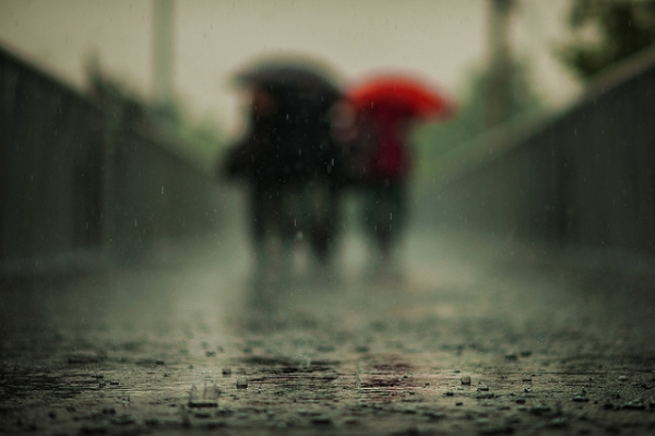 Friends take a walk in the rain in Guangminglou, Beijing, China on September 25, 2012. (Jonathan Kos-Read/Flickr)