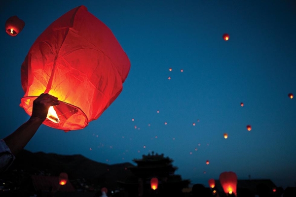 Residents of Ulaanbaatar set paper lanterns afloat at an event celebrating the birth of Buddha. (Taylor Weidman)