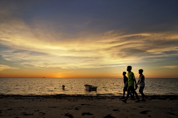 Three boys stroll along the beach at Labuan, Malaysia on April 16, 2013. (SaturatedEyes/Flickr)