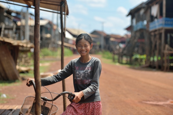 A girl and her bike in the fishing village of Kampong Khleang, Cambodia on May 4, 2013. (Jerry Donhal/Flickr)