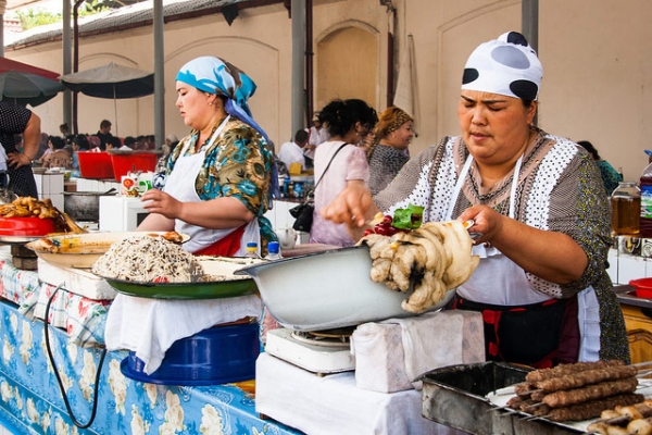 Two women hand-make traditional local cuisine in Tashkent, Uzbekistan on June 21, 2013. (Christopher Rose/Flickr)