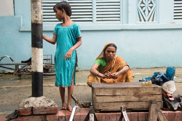 A mother and child anxiously wait for business in Dhaka, Bangladesh on June 26, 2013. (Sudipta Arka Das/Flickr)