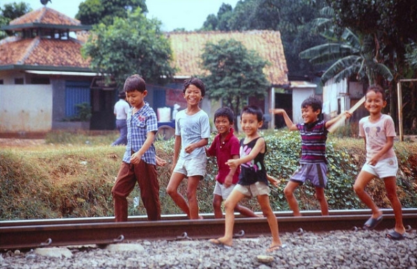 Children amuse themselves as they play along a railroad in West Java, Indonesia on September 11, 2013. (Kent Clark/Flickr) 