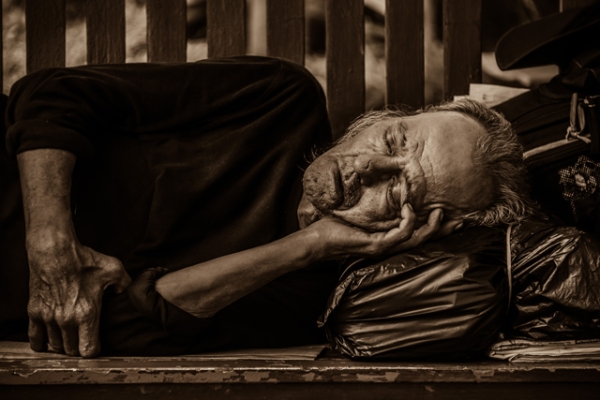 An old takes a nap on a bench in the open in Singapore on October 19, 2013. (Eduardo S. Seastres)