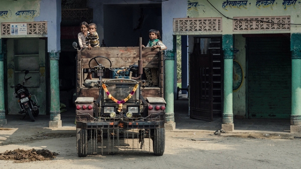 Children observe passersby from the back of a truck in India on November 6, 2013. (davidpc_/Flickr) 