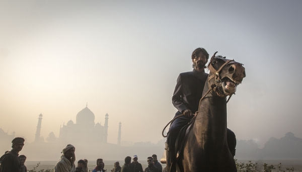 A man on a horse silhouetted by the Taj Mahal in the background in India on December 4, 2013. (Ville Hyvönen/Flickr)
