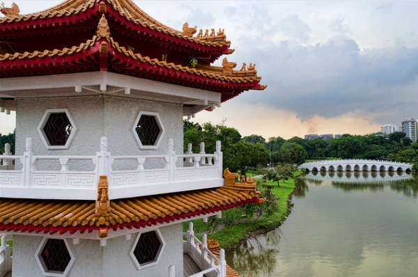 An intricate pagoda faces a white bridge in Singapore on December 14, 2013. (Pawandeep Singh/Flickr)