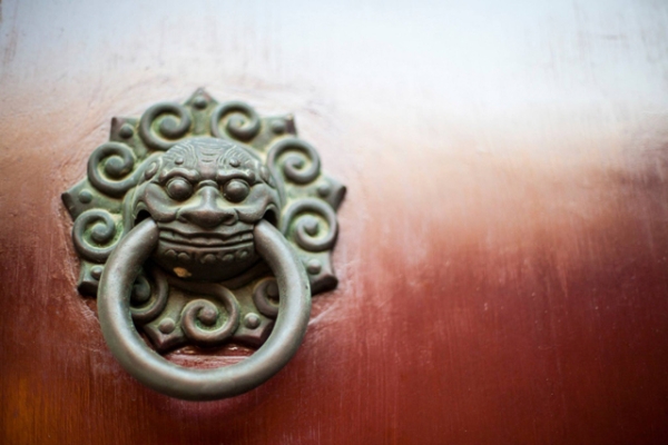 An ornate door knocker adorns a red door at Shanghai's City God Temple in China on November 30, 2013. (Tahiat Mahboob)