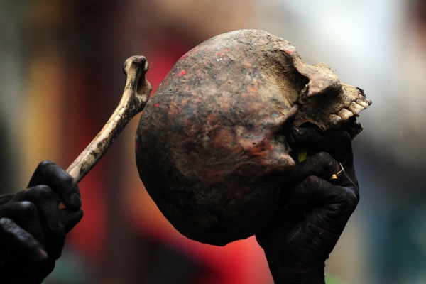 A devotee holds a human skull and bone during a procession for Maha Shivaratri in Allahabad, India on February 27, 2014. (Sanjay Kanojia/AFP/Getty Images)