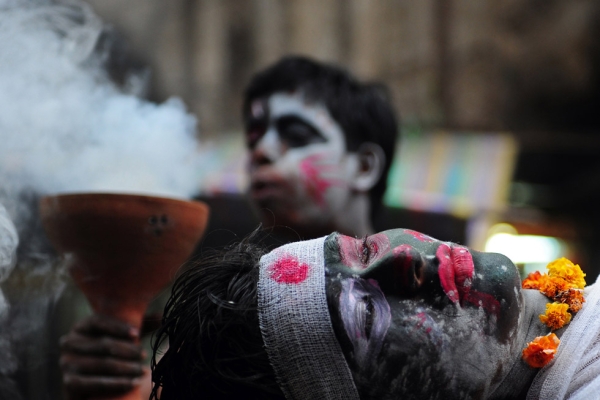 Hindu devotees perform a mock cremation ritual during a procession for Maha Shivaratri in Allahabad, India on February 27, 2014. (Sanjay Kanojia/AFP/Getty Images)