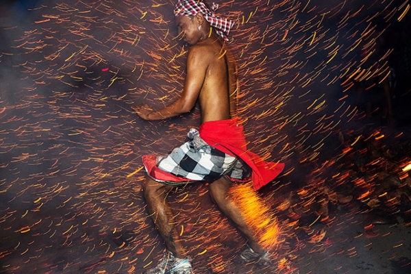 A Balinese man kicks up fire during the 'Mesabatan Api' ritual ahead of Nyepi Day in Gianyar, Bali, Indonesia on March 30, 2014. (Agung Parameswara/Getty Images)