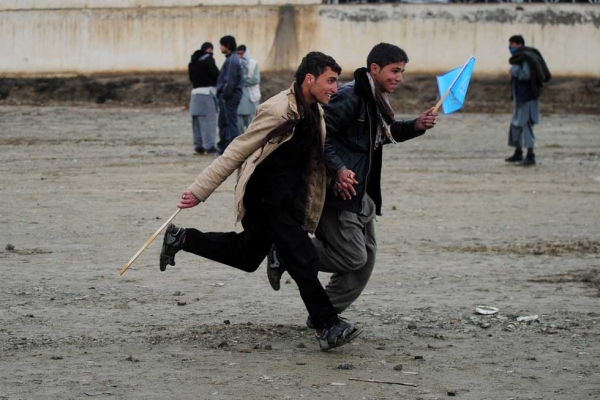 Supporters run to get a good spot near the stage after they entered a field to see presidential candidate Abdullah Abdullah speak at a rally on the last day of campaigning by presidential candidates on the outskirts of Kabul on April 2, 2014. (Roberto Schmidt/AFP/Getty Images)