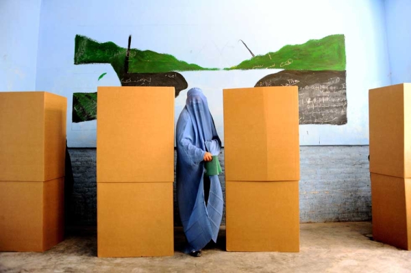 A woman leaves the booth after casting her vote at a polling station in the northwestern city of Herat on April 5, 2014. (Aref Karimi/AFP/Getty Images) 
