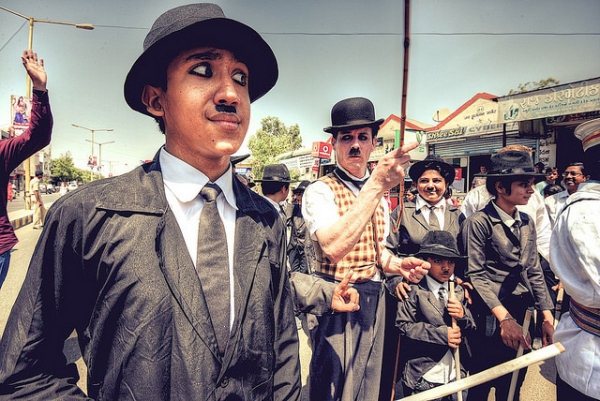 A few young men dress up like Charlie Chaplin to celebrate Chaplin's 125th birthday in Adipur, India on April 16, 2014. (Ashit Desai/Flickr)