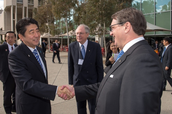 Shinzo Abe (L), Prime Minister of Japan, greets Warwick Smith (R), Chairman of Asia Society Australia, as Sir Rod Eddington, President Australia Japan Business Co-operation Committee, looks on in this photos taken July 8, 2014, in Canberra. (Irene Dowdy) 