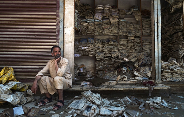 A Kashmiri shopkeeper reacts as he sits alongside a flood-damaged garment shop at the Lal Chowk area in Srinagar on September 17, 2014. (Dibyangshu Sarkar/AFP/Getty Images)