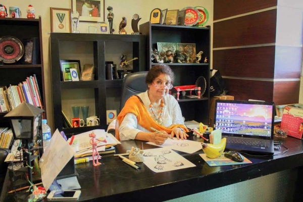 Shown here in her Islamabad office, Nigar Nazar is Pakistan's first professional female cartoonist. (Gogi Studios)